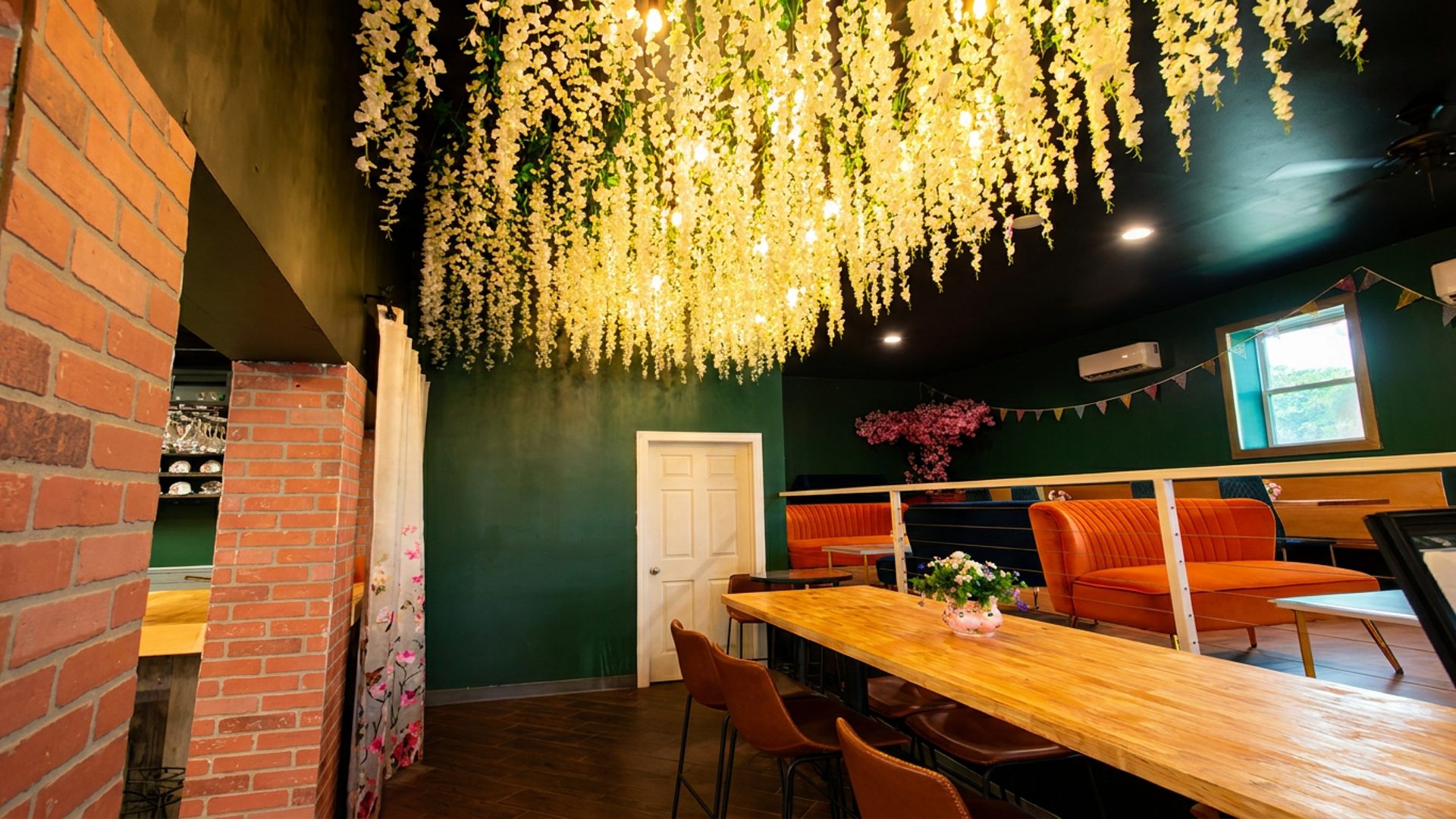 Hanging flowers, orange booths, warm light